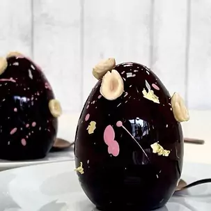 Two Easter eggs covered in black chocolate