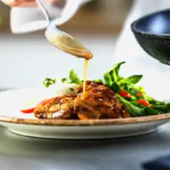 Chef plating a savory dish