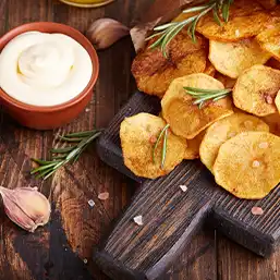 Golden fried potato chips with seasoned salt and served with dip