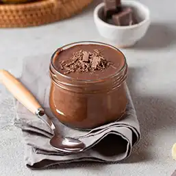 A glass pot of chocolate and banana spread